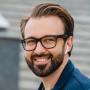 Feedback image, A cheerful man with glasses and a beard, symbolizing reliable modified roofing solutions in New Jersey.