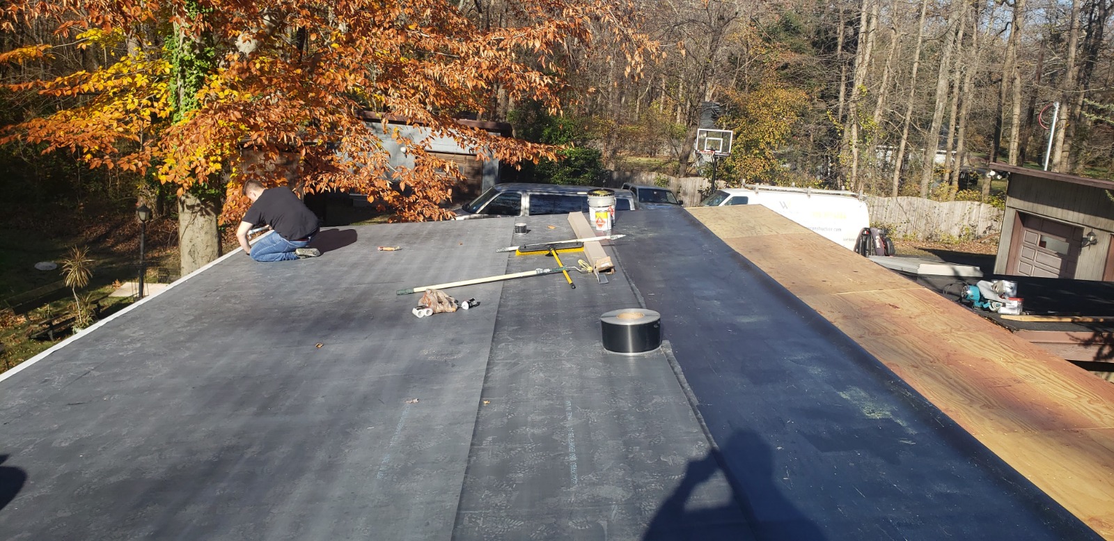 A flat roof featuring a ladder, illustrating the modified roofing solutions offered in New Jersey.